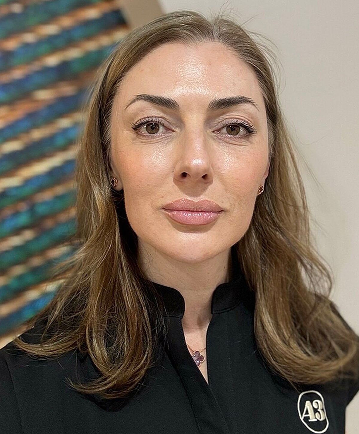 Person with light hair in black attire.